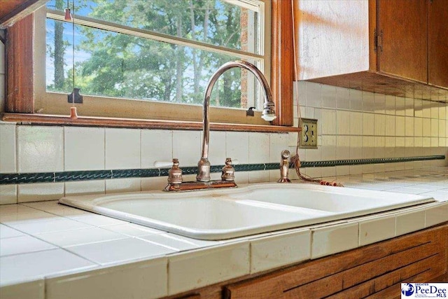 410 N Salem Dr, Florence, SC 29506 - room details with brown cabinets, tasteful backsplash, tile countertops, and a sink