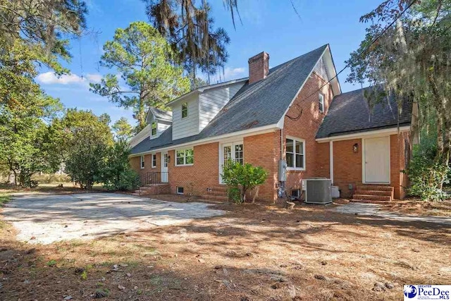 rear view of property featuring central AC