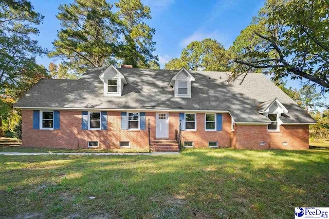 cape cod home featuring a front lawn