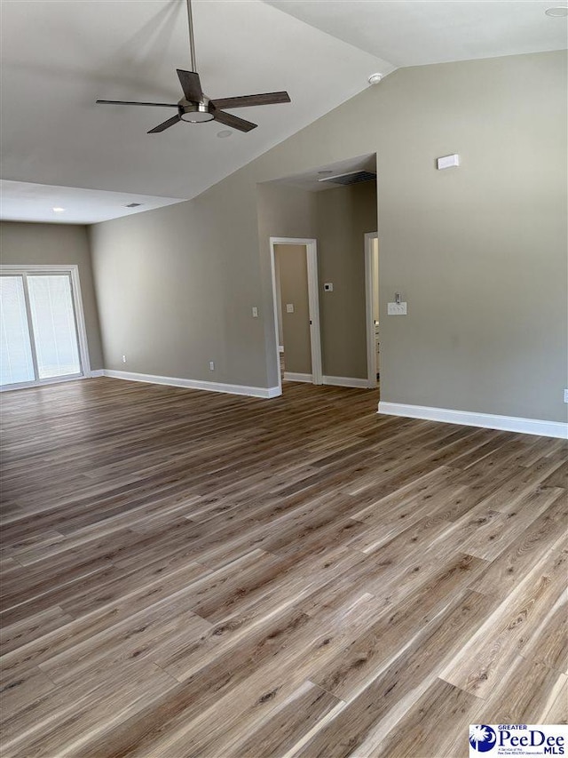 unfurnished living room featuring hardwood / wood-style floors, vaulted ceiling, and ceiling fan