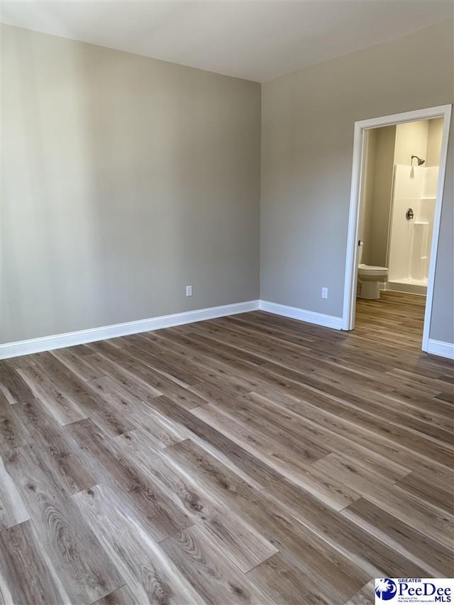 spare room with hardwood / wood-style flooring