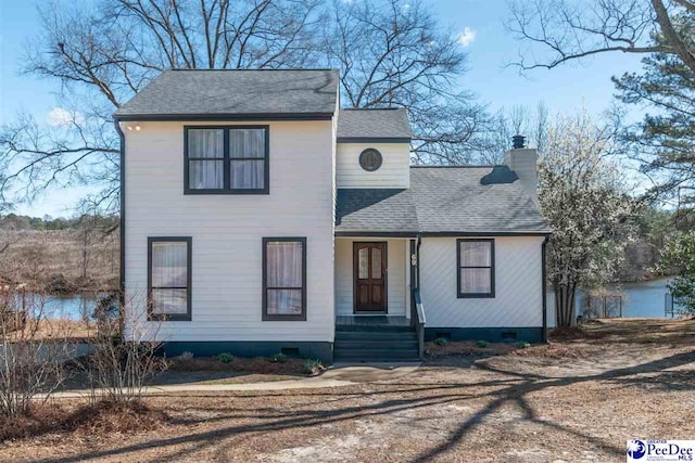 traditional home featuring roof with shingles, crawl space, covered porch, and a chimney