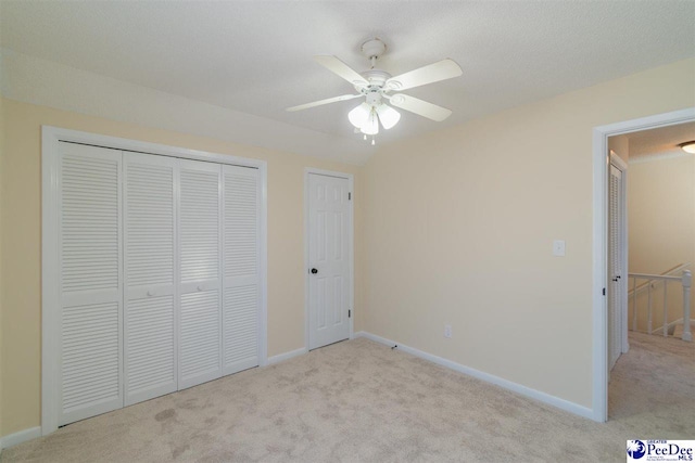 unfurnished bedroom with a closet, carpet flooring, and baseboards