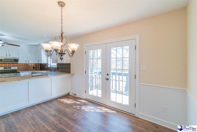 kitchen featuring decorative backsplash, a sink, stainless steel appliances, dark wood-type flooring, and french doors