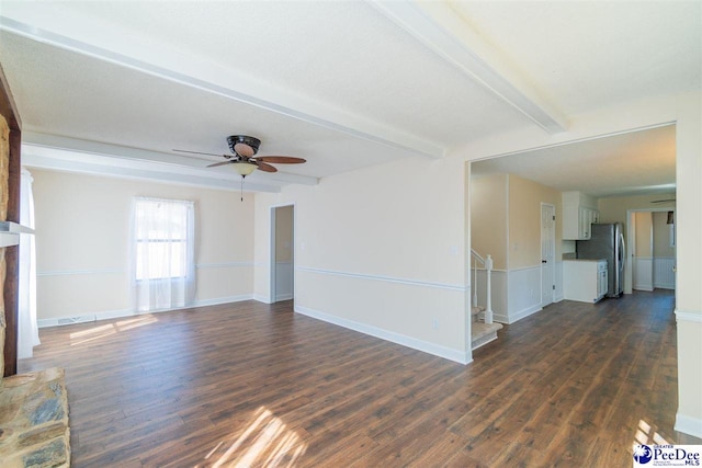 unfurnished living room with stairs, beam ceiling, dark wood finished floors, and a fireplace with raised hearth