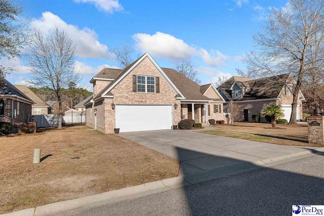 view of front of property featuring a garage and a front yard