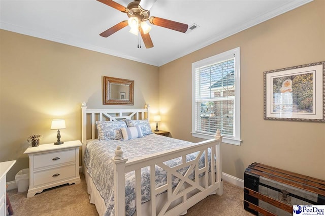 carpeted bedroom featuring crown molding and ceiling fan