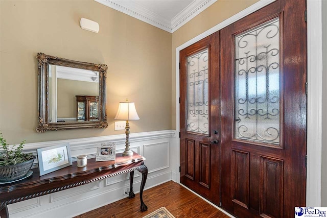 foyer with dark wood-type flooring and ornamental molding