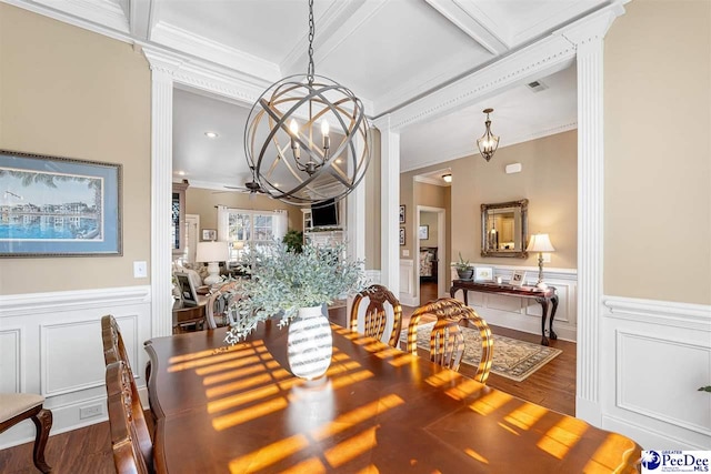 dining area featuring decorative columns, crown molding, hardwood / wood-style flooring, beamed ceiling, and ceiling fan with notable chandelier