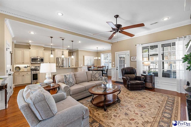 living room with ornamental molding, ceiling fan with notable chandelier, and light hardwood / wood-style flooring