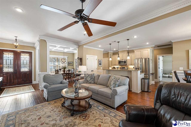 living room with ceiling fan, ornamental molding, and dark hardwood / wood-style floors