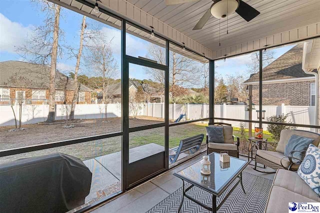 sunroom with wooden ceiling and ceiling fan