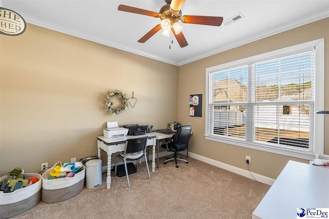 office space featuring crown molding, light carpet, and ceiling fan