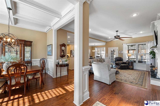 living room featuring ornamental molding, ceiling fan with notable chandelier, and dark hardwood / wood-style flooring