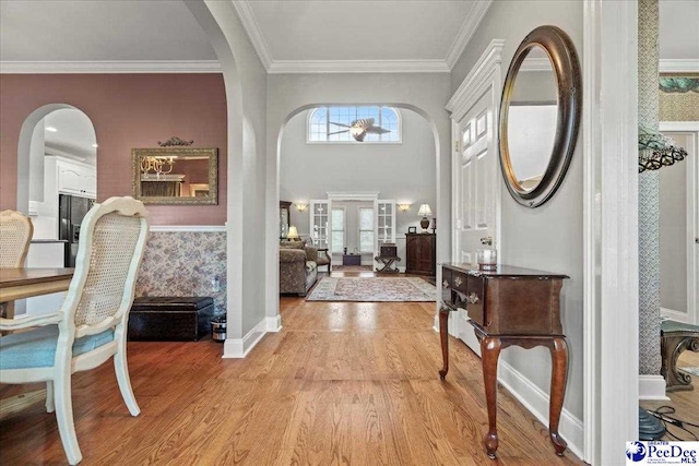 526 Shannon Rd, Marion, SC 29571 - entrance foyer with ornamental molding, baseboards, light wood finished floors, and arched walkways