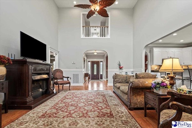 526 Shannon Rd, Marion, SC 29571 - living area featuring visible vents, arched walkways, a high ceiling, light wood-type flooring, and a ceiling fan
