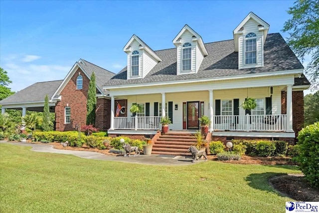 526 Shannon Rd, Marion, SC 29571 - cape cod home with a porch, a shingled roof, a front yard, and brick siding