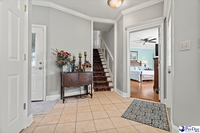 526 Shannon Rd, Marion, SC 29571 - entryway with light tile patterned floors, baseboards, a ceiling fan, crown molding, and stairs