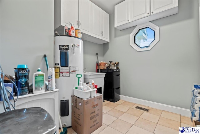 526 Shannon Rd, Marion, SC 29571 - laundry area with water heater, visible vents, and baseboards