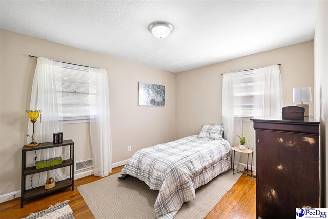 2105 W Downing St, Florence, SC 29501 - bedroom featuring wood finished floors and baseboards