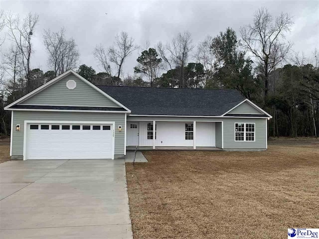 ranch-style house with a front lawn, concrete driveway, and an attached garage