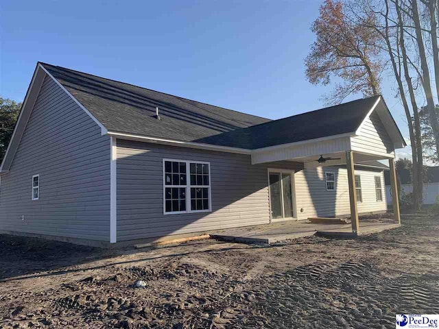 back of property featuring a patio, a shingled roof, and a ceiling fan