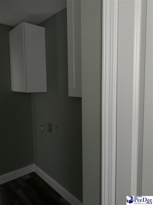 washroom with washer hookup, cabinet space, dark wood finished floors, and baseboards