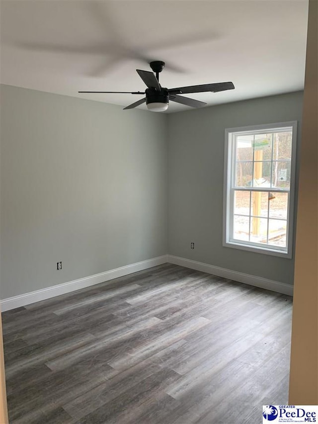 unfurnished room featuring a ceiling fan, baseboards, and wood finished floors