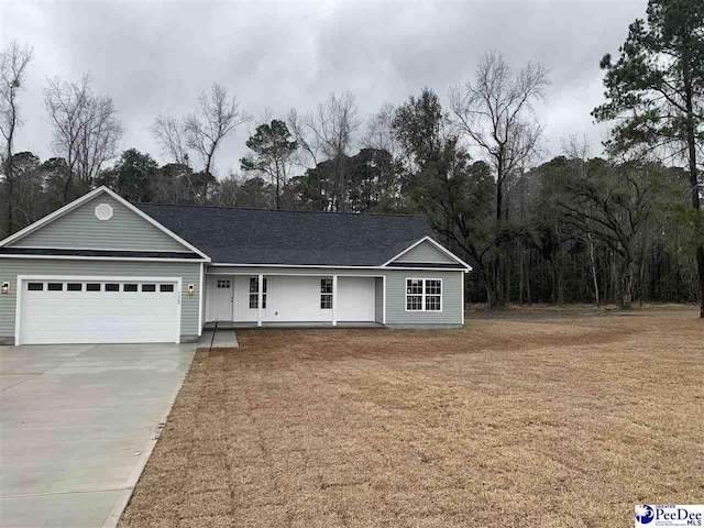 single story home featuring a garage, a front yard, and driveway