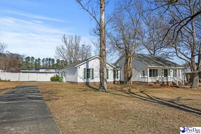 view of home's exterior featuring a yard and covered porch