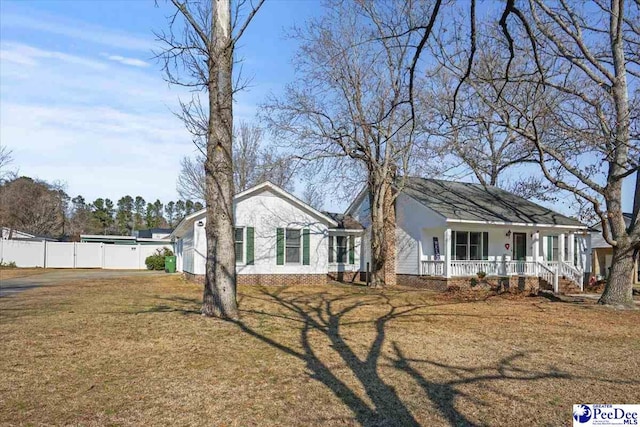 ranch-style home with covered porch and a front lawn