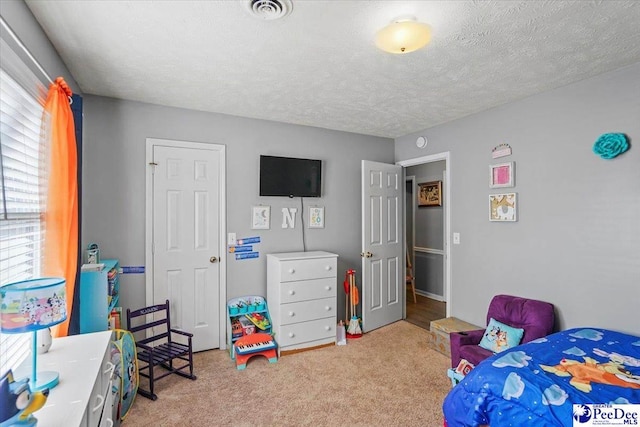 carpeted bedroom with a textured ceiling