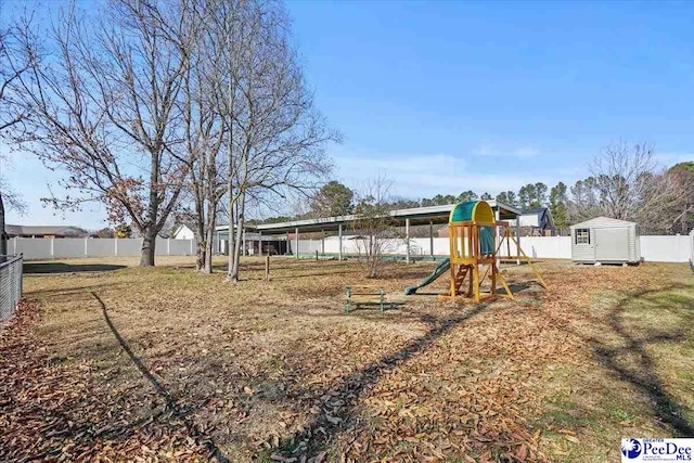 view of jungle gym with a storage unit