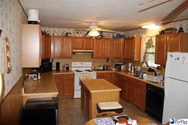 kitchen featuring sink, white appliances, ceiling fan, a center island, and wood counters