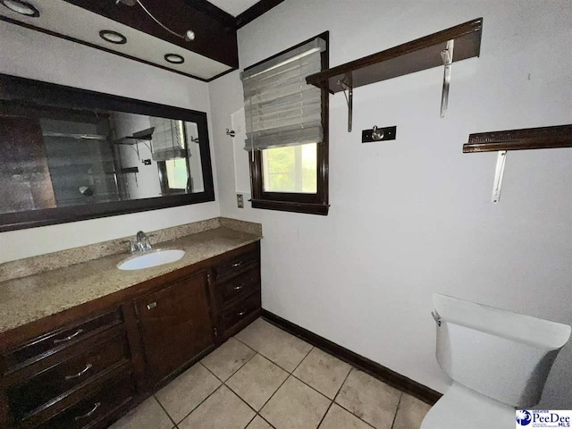 bathroom with vanity, toilet, and tile patterned flooring