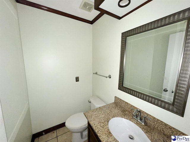 bathroom with vanity, ornamental molding, tile patterned floors, and toilet