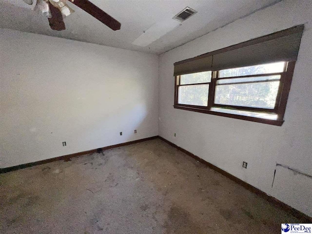 carpeted spare room featuring ceiling fan