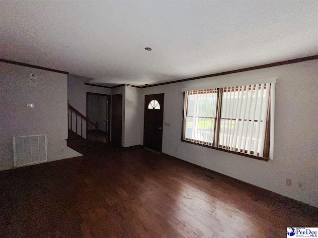 interior space with crown molding and hardwood / wood-style flooring