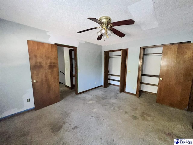 unfurnished bedroom with multiple closets, ceiling fan, and a textured ceiling