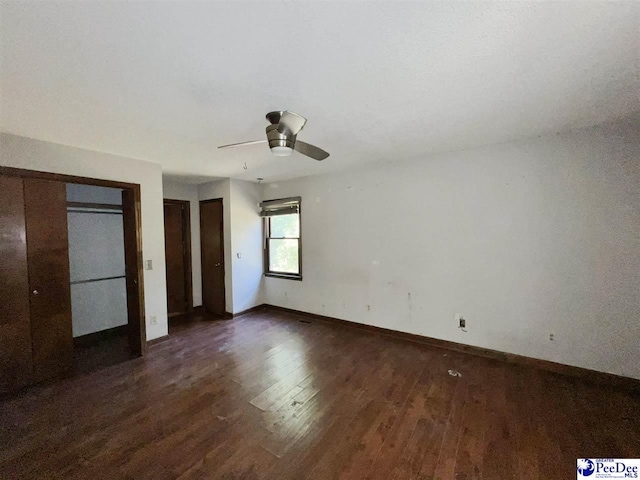 unfurnished bedroom featuring dark hardwood / wood-style flooring and ceiling fan