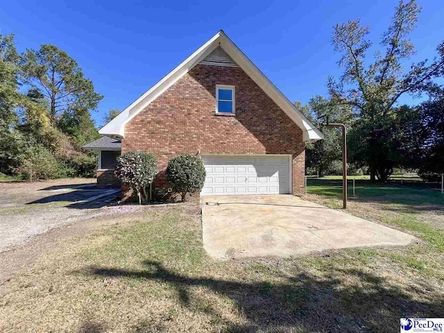 view of property exterior featuring a garage and a lawn