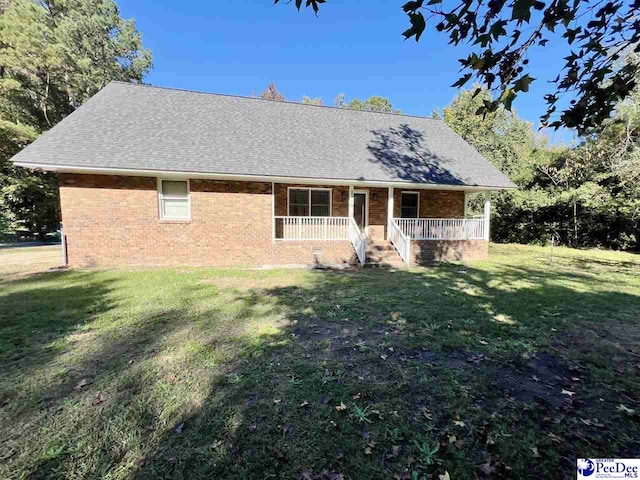 view of front of home with covered porch and a front lawn