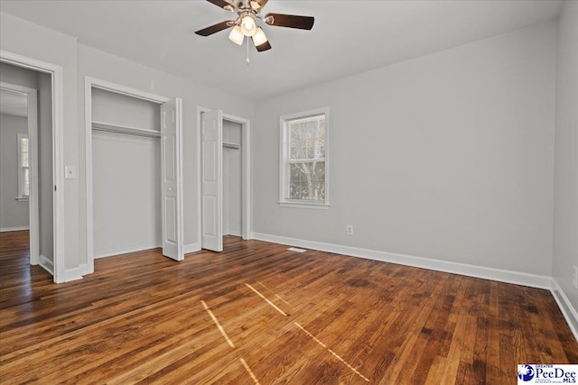 1933 3rd Loop Unit A, Florence, SC 29501 - unfurnished bedroom with multiple windows, two closets, baseboards, and wood finished floors