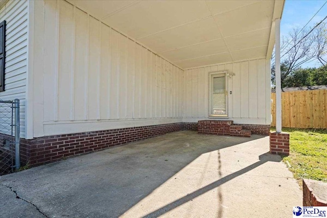 1933 3rd Loop Unit A, Florence, SC 29501 - view of patio / terrace with fence, an attached carport, and entry steps