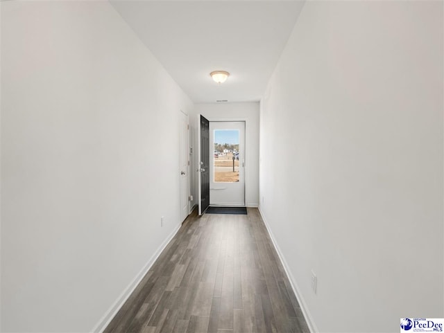 hall featuring dark wood finished floors and baseboards