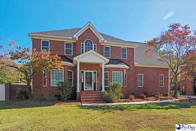 colonial-style house with a front yard