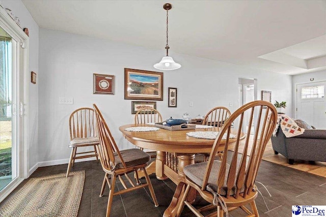 dining space featuring dark wood-style floors and baseboards