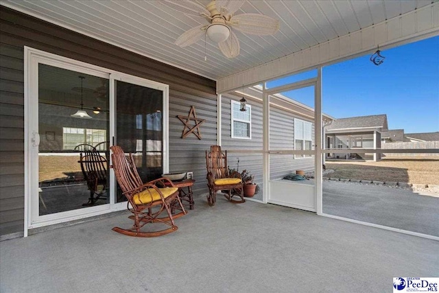 sunroom featuring ceiling fan