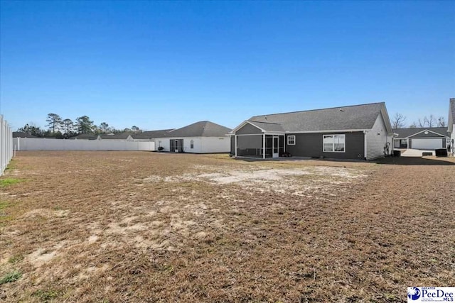 back of house with a fenced backyard