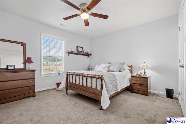 bedroom with light carpet, ceiling fan, visible vents, and baseboards